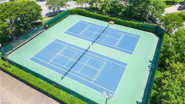 view of tennis court featuring fence