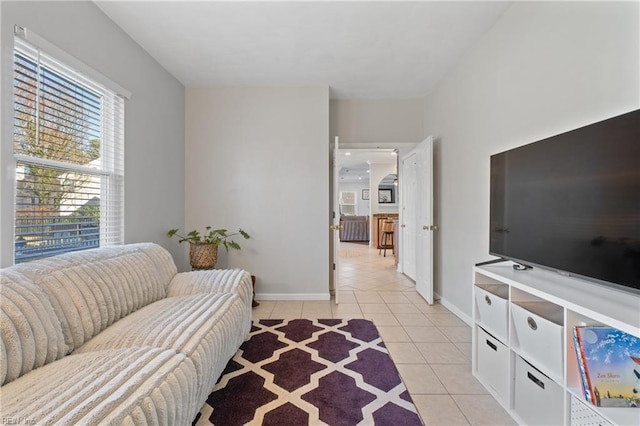 living room featuring light tile patterned floors and baseboards