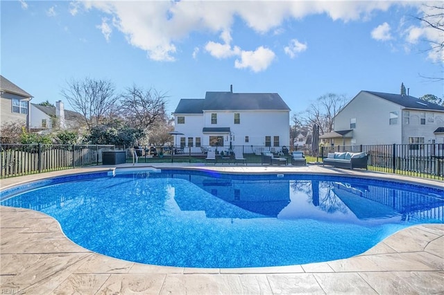 view of swimming pool with a patio, fence, a fenced in pool, a residential view, and an outdoor hangout area