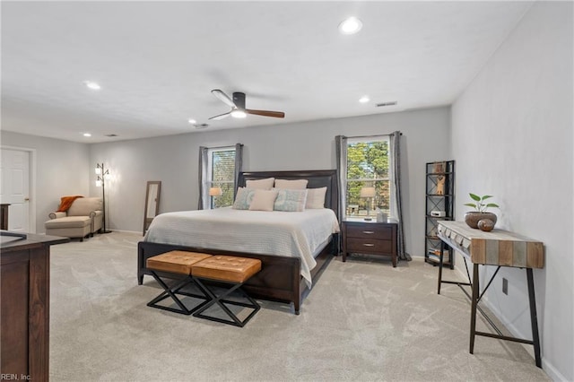 bedroom with multiple windows, visible vents, and light carpet