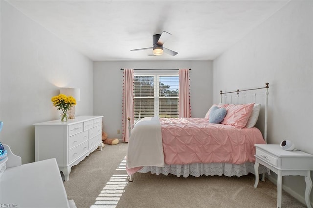 bedroom with light carpet and a ceiling fan