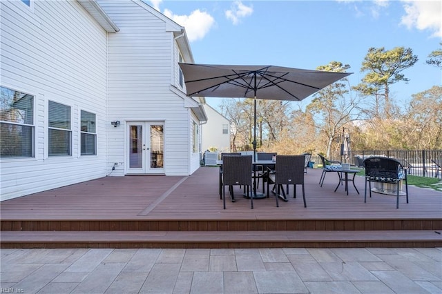 wooden terrace featuring outdoor dining space and french doors