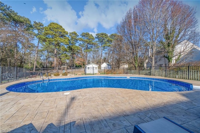 view of swimming pool with a patio area, a fenced in pool, and fence