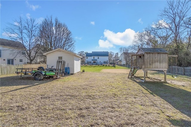 view of yard with an outdoor structure and fence