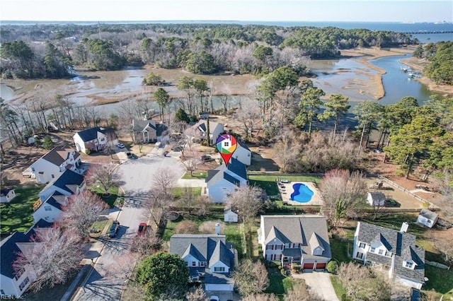 drone / aerial view featuring a forest view and a water view