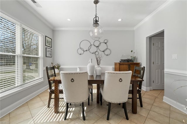 dining room with light tile patterned floors, visible vents, baseboards, and ornamental molding