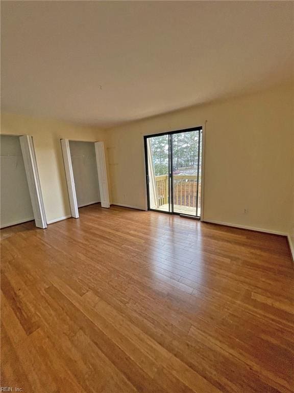 unfurnished room featuring wood finished floors and baseboards