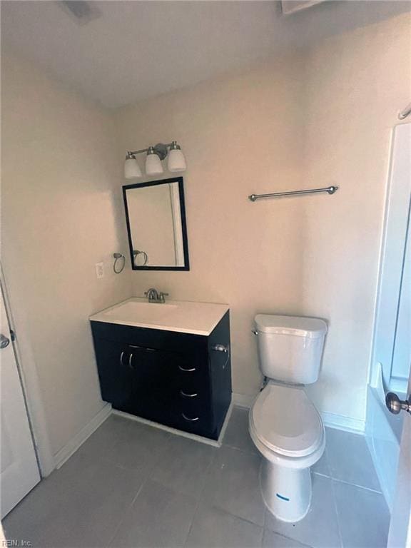 full bath featuring vanity, toilet, baseboards, and tile patterned flooring