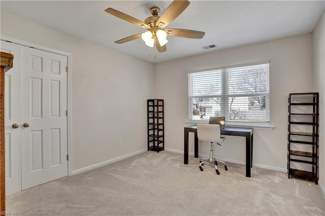 carpeted office space with visible vents, baseboards, and ceiling fan