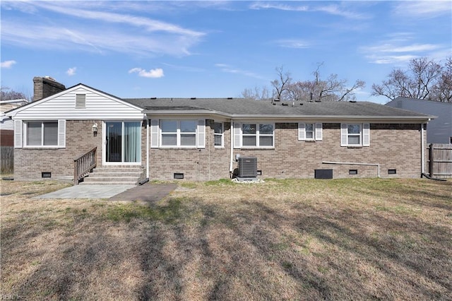 back of property featuring entry steps, brick siding, and crawl space