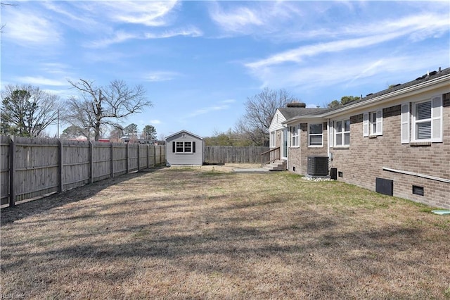 view of yard with entry steps, an outdoor structure, a fenced backyard, and central AC