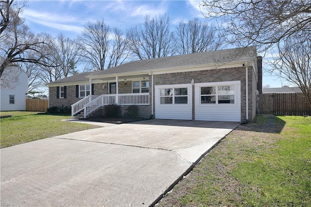 single story home featuring a front yard, fence, a porch, concrete driveway, and brick siding