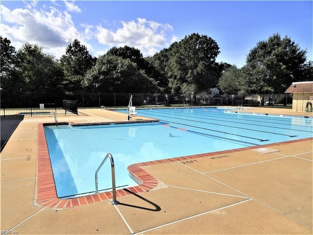 community pool featuring a patio and fence