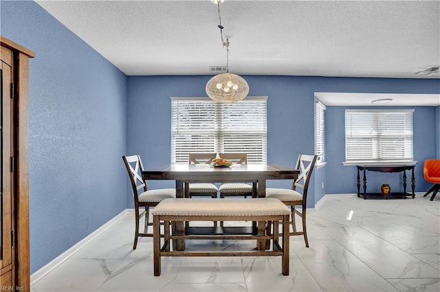 dining area with visible vents, baseboards, marble finish floor, and a textured ceiling