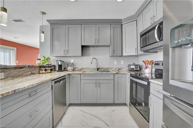 kitchen with gray cabinets, appliances with stainless steel finishes, marble finish floor, and a sink