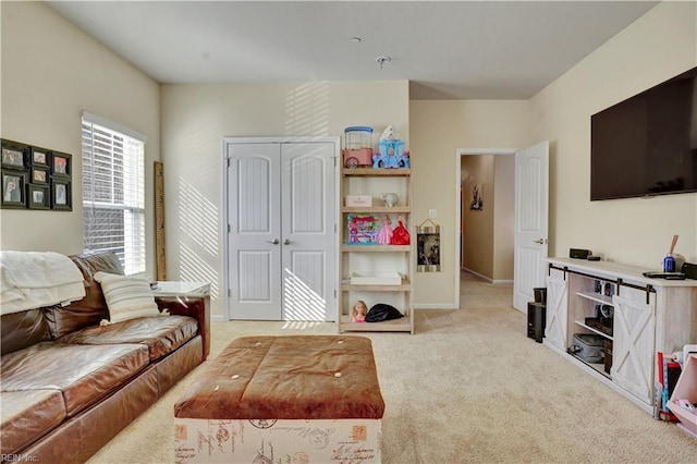 living area featuring light colored carpet and baseboards