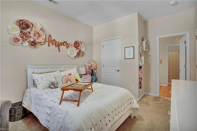 bedroom featuring visible vents, light carpet, and baseboards