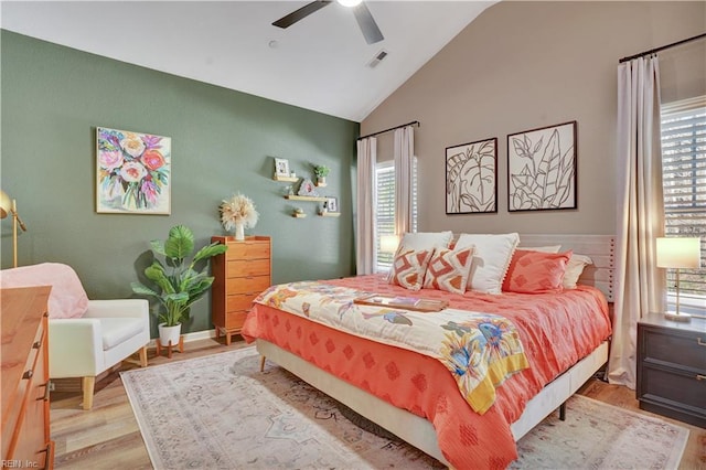 bedroom with visible vents, wood finished floors, a ceiling fan, and vaulted ceiling