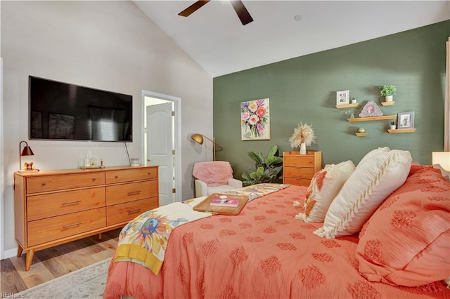 bedroom featuring high vaulted ceiling, wood finished floors, and a ceiling fan