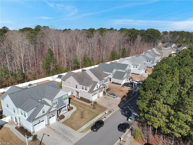 birds eye view of property featuring a wooded view and a residential view