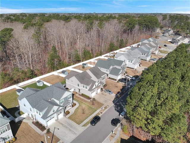 birds eye view of property featuring a forest view and a residential view