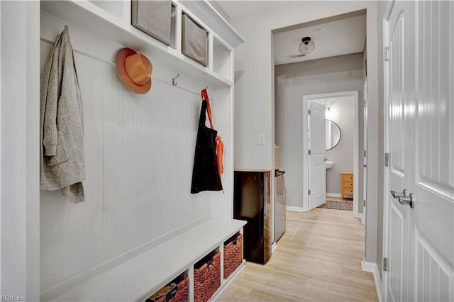 mudroom with light wood-style flooring and baseboards