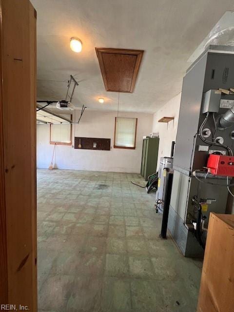 hall featuring tile patterned floors and attic access