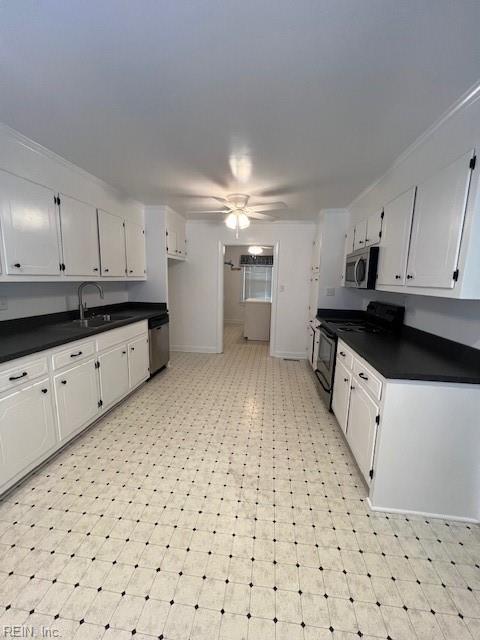 kitchen featuring light floors, ceiling fan, stainless steel appliances, white cabinetry, and dark countertops