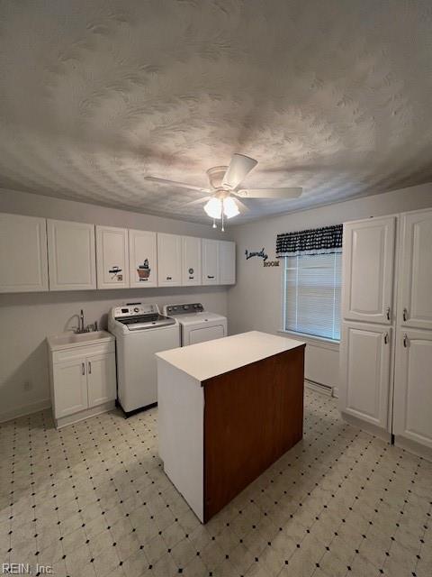 washroom with ceiling fan, cabinet space, light floors, and washing machine and clothes dryer