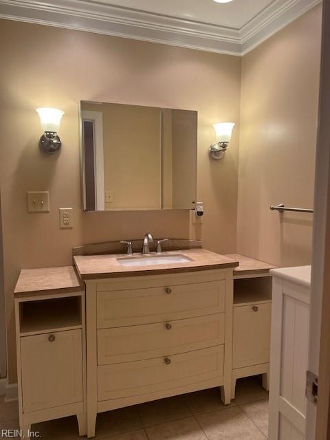 bathroom with tile patterned flooring, vanity, and crown molding