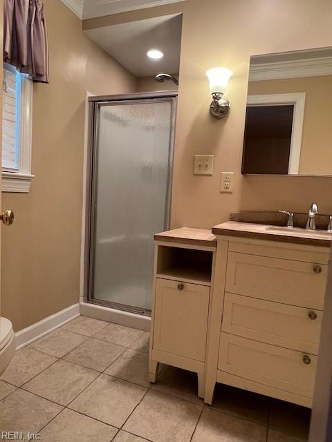 full bath with vanity, a stall shower, crown molding, and tile patterned flooring