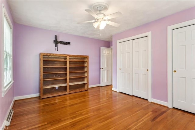 307 Ridgeland Dr, Smithfield, VA 23430 - unfurnished bedroom with a ceiling fan, wood finished floors, baseboards, and baseboard heating
