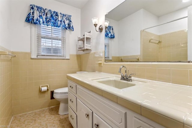 307 Ridgeland Dr, Smithfield, VA 23430 - full bath featuring vanity, a wainscoted wall, a tile shower, tile walls, and toilet