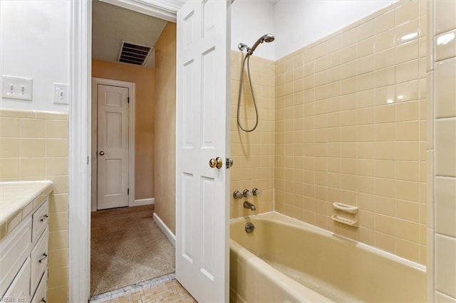 307 Ridgeland Dr, Smithfield, VA 23430 - bathroom with bathtub / shower combination, tile walls, vanity, and visible vents