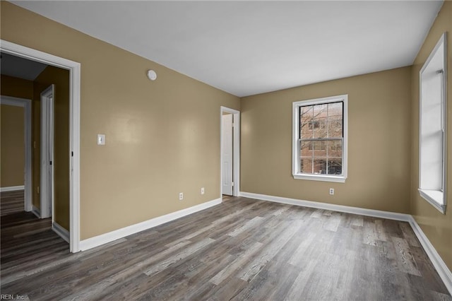 empty room with wood finished floors and baseboards