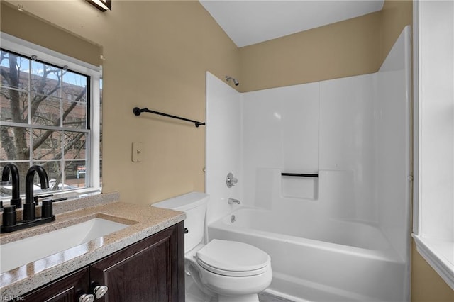 bathroom with vanity, toilet, and washtub / shower combination