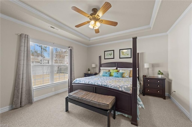 bedroom featuring visible vents, a tray ceiling, carpet floors, crown molding, and baseboards