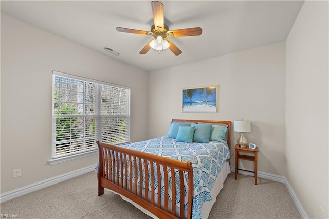 bedroom featuring carpet flooring, visible vents, a ceiling fan, and baseboards