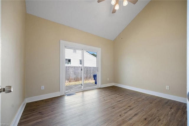 spare room featuring visible vents, high vaulted ceiling, wood finished floors, baseboards, and ceiling fan