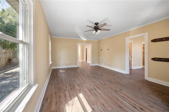 spare room with ceiling fan, ornamental molding, baseboards, and wood finished floors