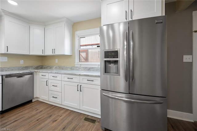 kitchen with dark wood finished floors, white cabinets, visible vents, and stainless steel appliances