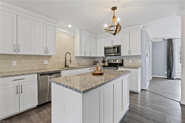 kitchen with a sink, dark wood-type flooring, white cabinets, and stainless steel appliances