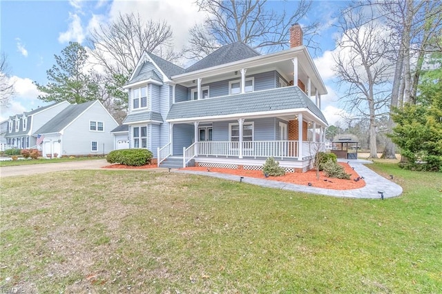 view of front of home featuring a porch, a front yard, a chimney, a garage, and driveway