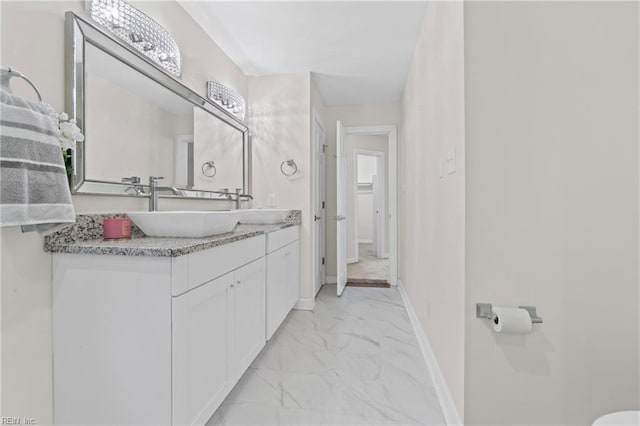 bathroom with vanity, baseboards, and marble finish floor