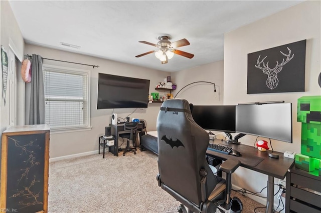 office space with a ceiling fan, carpet, visible vents, and baseboards