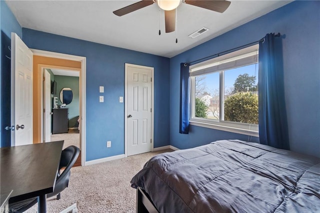 carpeted bedroom with visible vents, baseboards, and ceiling fan