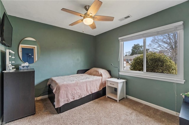 bedroom with visible vents, baseboards, carpet floors, and ceiling fan