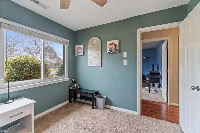 interior space featuring visible vents, carpet flooring, and baseboards