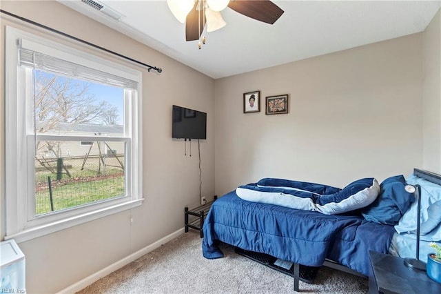 carpeted bedroom with visible vents, ceiling fan, and baseboards