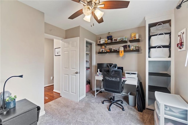 office space featuring a ceiling fan, baseboards, and carpet floors